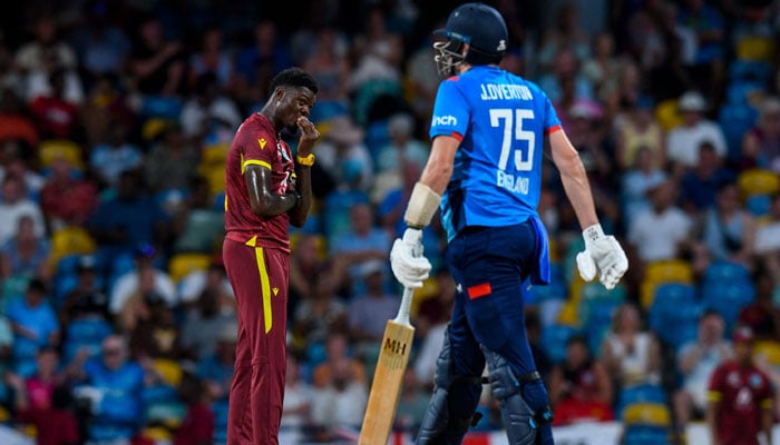 Alzarri Joseph (left) of West Indies express disappointment after Jamie Overton (right) of England hits 4 during the 3rd and final ODI match between West Indies and England at Kensington Oval, Bridgetown, Barbados, on November 6, 2024. — AFP