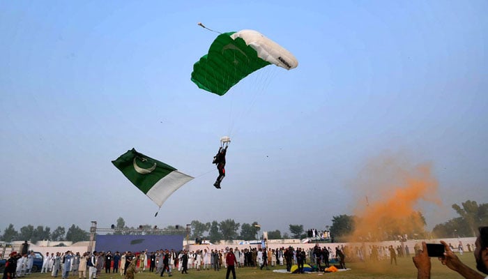 Paratroopers put on an impressive aerial performance during a horse and cattle show organised by the Directorate General of Sports Khyber Pakhtunkhwa at Col Sher Khan Stadium on November 8, 2024. — APP