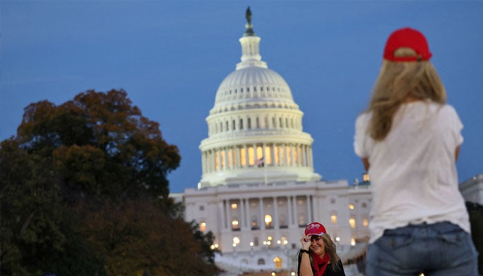 Trump supporters take photographs near the US Capitol building as the sun sets the day US president-elect Donald Trump was declared the winner of the presidential election in Washington, US, November 6, 2024. — Reuters