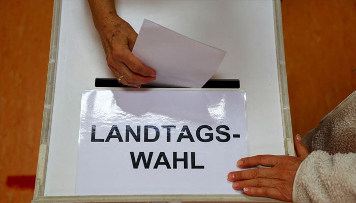 A voter casts their vote in the ballot box during the Brandenburg state election in Forst, Germany, September 22, 2024. — Reuters