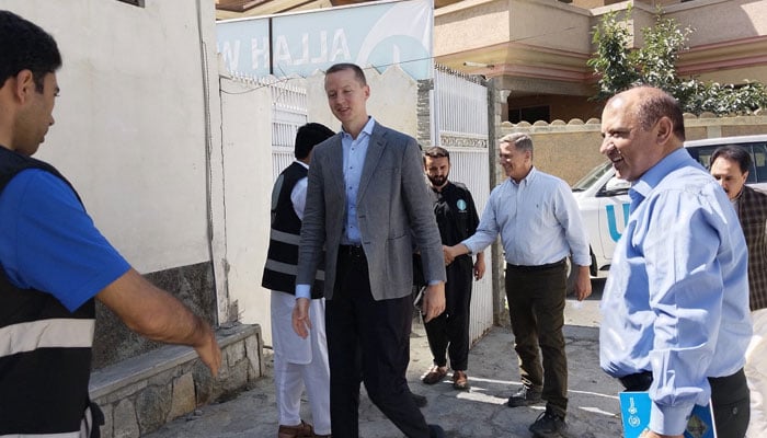 Eric Kenefick (centre), a representative from World Food Programme (WFP), seen walking in this image. — allahwalaytrustpakistan/file