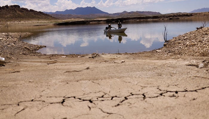 Fishermen  sail in a boat at the Luis L. Leon El Granero dam affected by the drought in the municipality of Aldama, in Chihuahua state, Mexico on August 3, 2022. — Reuters