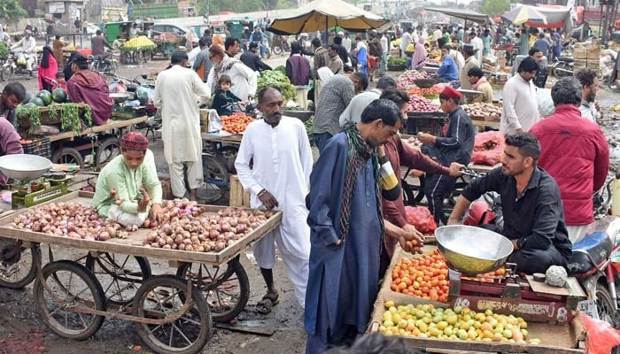 Vendors are selling vegetables at a market in Lahore. — Online/file