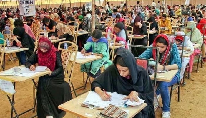 Candidates are writing on the answer sheets during the Medical and Dental College Admission Test (MDCAT). — PPI/File