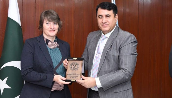 Regional Head of the Goethe Institut Dr Alexandra Mittler poses for a photo as she receives a shield from NUML DG Brig Shahzad Munir in this image released on November 6, 2024. — Facebook@NUMLOFFICIALPAGE