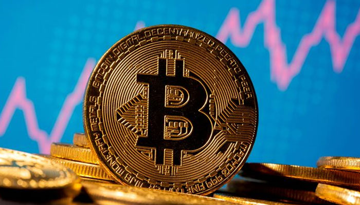 A representation of virtual currency Bitcoin is seen in front of a stock graph in this image taken on November 19, 2020. — Reuters