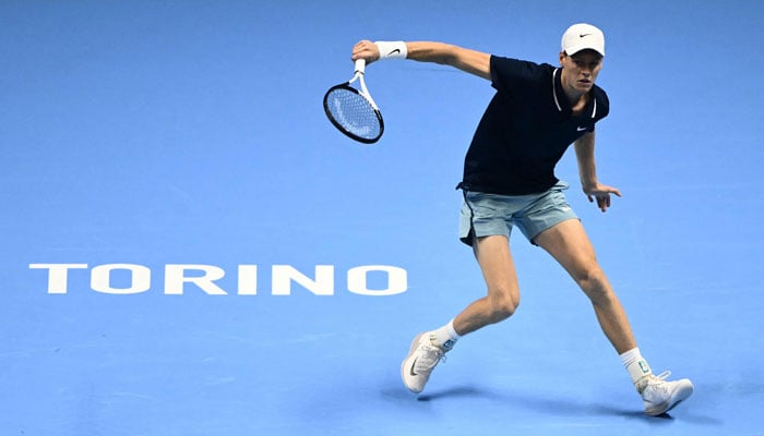 Italy´s Jannik Sinner hits a return to Australia´s Alex de Minaur during their match at the ATP Finals tennis tournament in Turin on November 10, 2024. — AFP