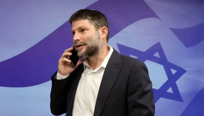 Israeli Minister of Finance and leader of the Religious Zionist Party Bezalel Smotrich talking on phone at the prime ministers office in Jerusalem on March 5, 2023. — Reuters