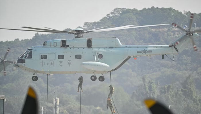 Soldiers demonstrate their combat capabilities by descending from a helicopter during the 15th China International Aviation and Aerospace Exhibition in Zhuhai, in south Chinas Guangdong province on November 12, 2024.— AFP