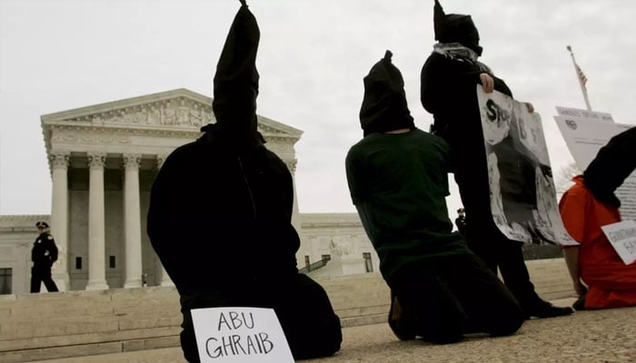 Activists taking part in a demonstration opposing human rights violations at Abu Ghraib prison in Iraq by US military personnel, in front of US Supreme Court, on 9 February 2005 in Washington, DC. — Reuters