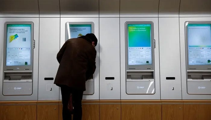 A man uses an ATM machine in an office of the Russian largest lender Sberbank in Moscow, Russia December 24, 2020 in this picture taken on December 24, 2020.— Reuters