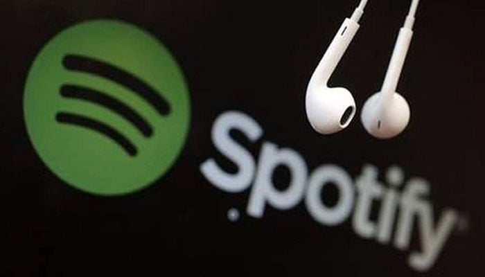 Headphone hanging on a computer screen with the logo of  Spotify. — AFP/File