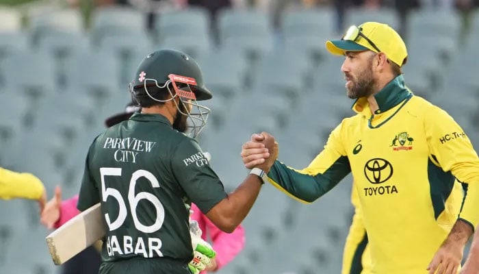 Pakistan batter Babar Azam (left) shaking hand with an Australias Glenn Maxwell. — AFP/File