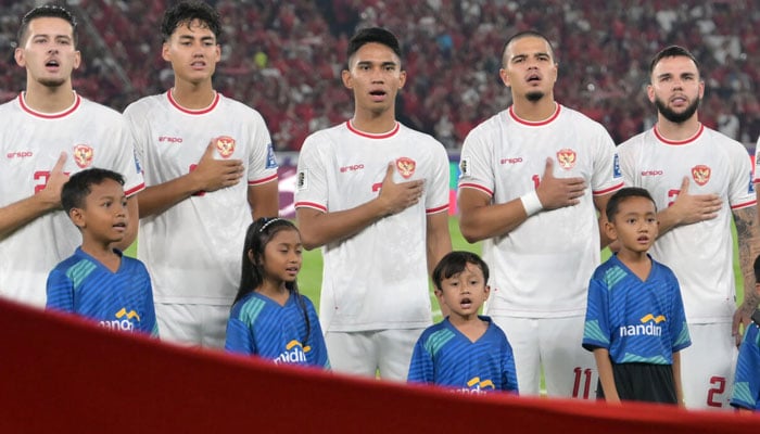 Indonesias players sing the national anthem ahead of a World Cup qualifier. — AFP/File