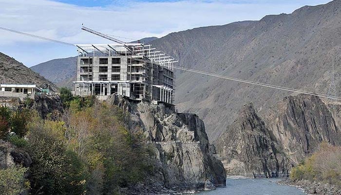 A view of under construction Bejaan Hotel at bank of Chitral River. — APP/File