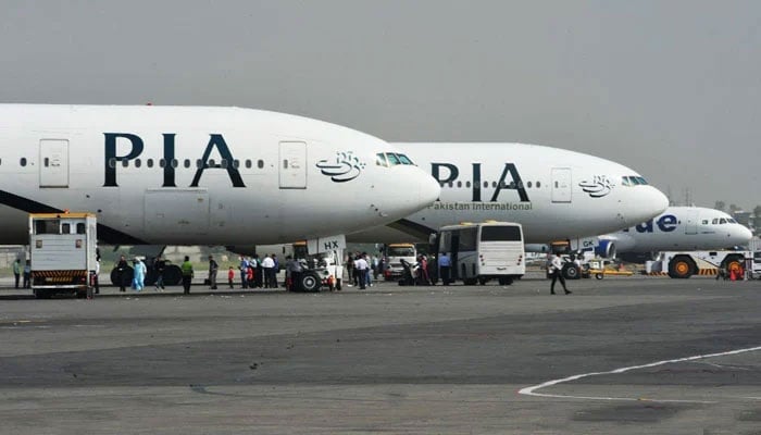 Pakistan International Airlines (PIA) aircraft are parked on the runway. — AFP/File