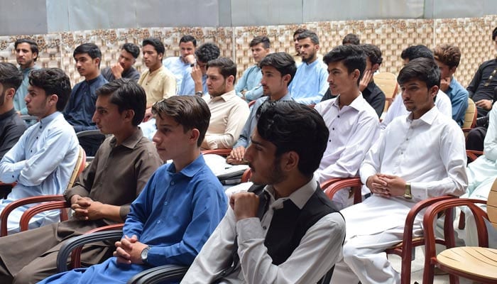 A representational image of young men sitting in a classroom. — Facebook@DistrictYouthAffairsShangla