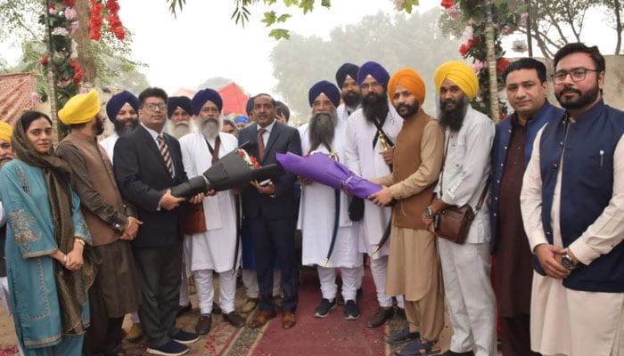 Indian Sikh pilgrims are being welcomed with flower bouquets as they arrive in Lahore via Wagha Border to participate in the birth anniversary of Baba Guru Nanak on November 14, 2024. — Facebook@Evacuee TrustPropertyBoard