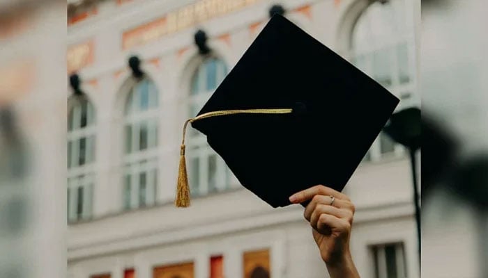 This representational image shows an unidentified individual holding a graduation cap. — Unsplash/File