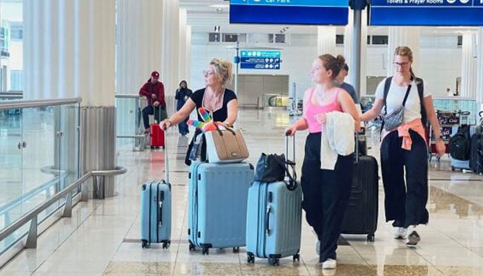 A representational image showing people with their luggage at an airport. — Reuters/file