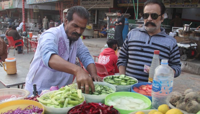 A street vendor is selling salad at Liaqatabad area to earn daily wages.— ONLINE/File