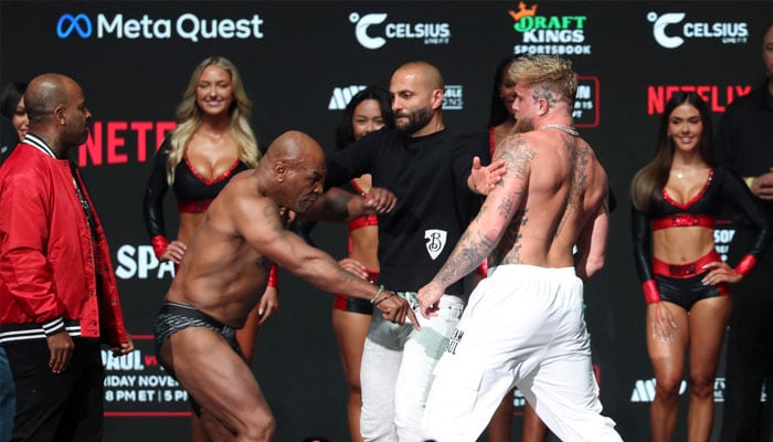 Jake Paul (right) and Mike Tyson face off during weigh-ins at the Toyota Music Factory the day before their fight. — Reuters/file