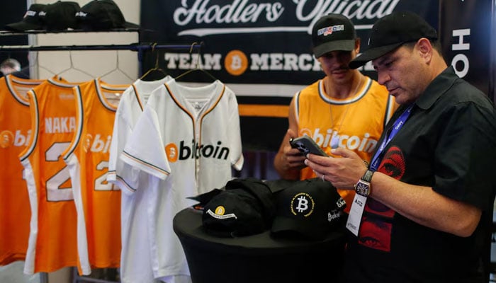 A man pays for a jersey with Bitcoin during the launch of Adopting Bitcoin 2024. — Reuters/file