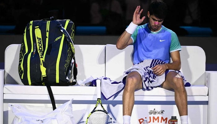 Spains Carlos Alcaraz sits between games during his mens singles match against Germanys Alexander Zverev during their match at the ATP Finals tennis tournament in Turin on November 15, 2024. — AFP