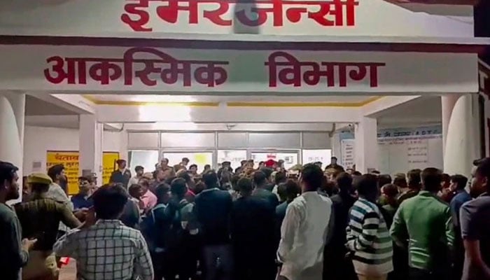 People gather outside the emergency ward after a fire broke out in the Neonatal Intensive Care Unit of the Maharani Laxmi Bai Medical College, in Jhansi district on Saturday. — PTI