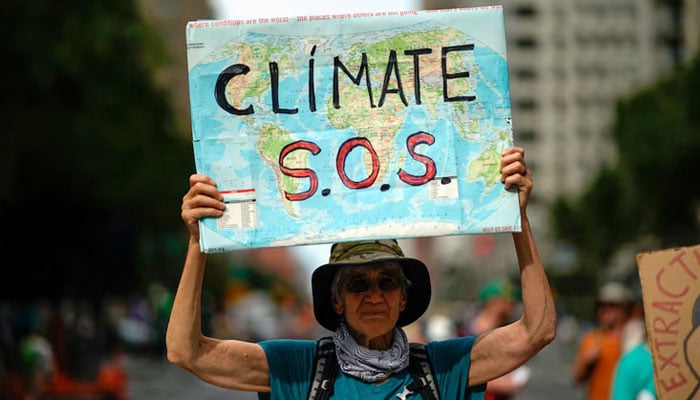 A man holds a sign as activists mark the start of Climate Week in New York during a demonstration calling for the U.S. government to take action on climate change and reject the use of fossil fuels in New York City, New York, US, September 17, 2023. — Reuters