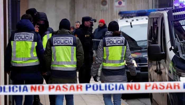 This representational image shows Spanish police officers outside a building after the arrest of a man. — Reuters/File