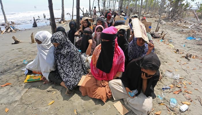 Rohingya Muslim women rest after landing by boat at the coast of Meunasah Asan Village in East Aceh, Aceh province, Indonesia, on October 31, 2024. — Reuters