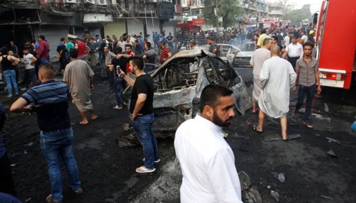 A representational image shows people gathered at a bombsite in Iraq. — Reuters/File