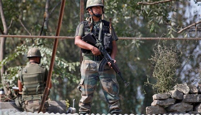 An undated image showing Indian army soldiers keep guard on top of a shop along a highway. — Reuters/File