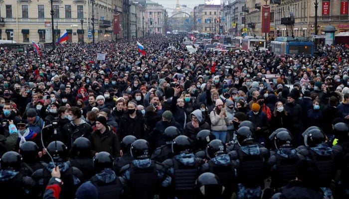 Law enforcement officers stand in front of participants during a rally in support of jailed Russian opposition leader Alexei Navalny in Saint Petersburg on January 23, 2021. — Reuters