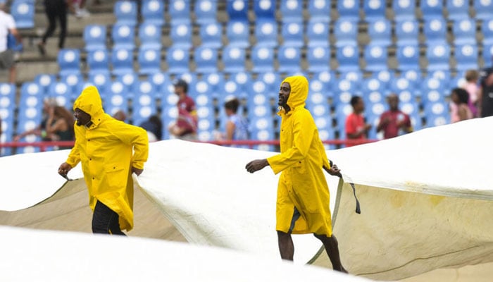 Ground staff cover the field in Saint Lucia during the West Indies v England T20 international.— AFP/File