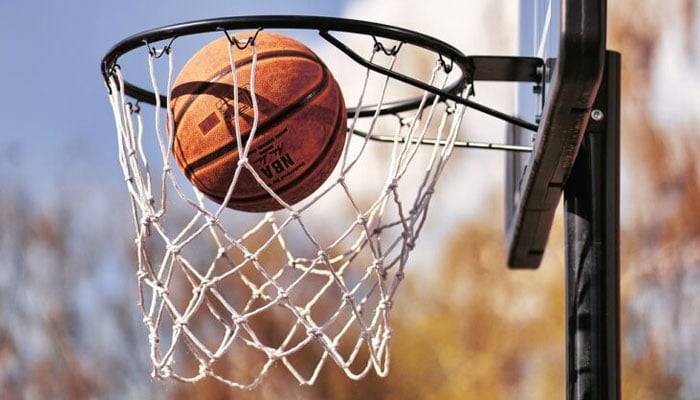 A representational image of basketball falling from the net. — APP/file