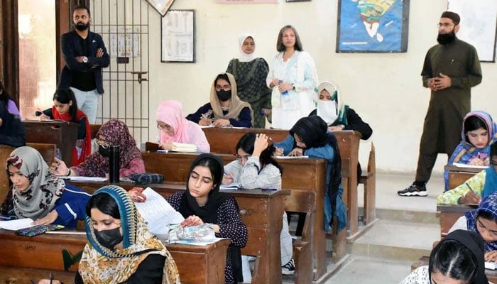 Students solve their questionnaire during the entry test for different programs, at Karachi University premises in Karachi on November 10, 2024. — PPI