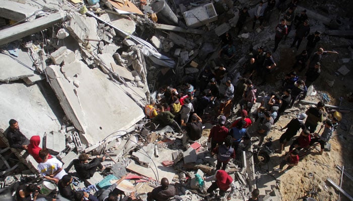 Palestinians, including rescuers, search for casualties at the site of an Israeli strike on a house, in Gaza City on November 18, 2024. — Reuters