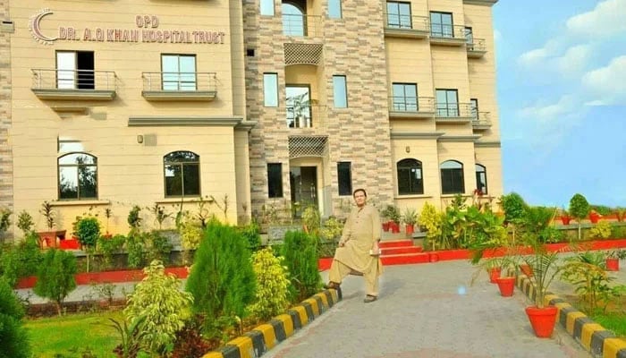 A person stands in front of Dr AQ Khan Hospital Trust building on January 20, 2024. — Facebook@aqkhospitaltrust