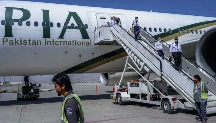 Crew members disembark from a Pakistan International Airways (PIA) flight at Kabul Airport, Afghanistan on September 13, 2021. — AFP