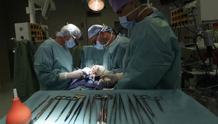 Doctors performing a surgery in an operation theatre. — Reuters/file