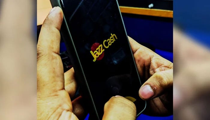 This image taken on August 19, 2024, shows a user opening a digital application JazzCash on his mobile phone in Karachi. — Geo. tv/Kashif Suri