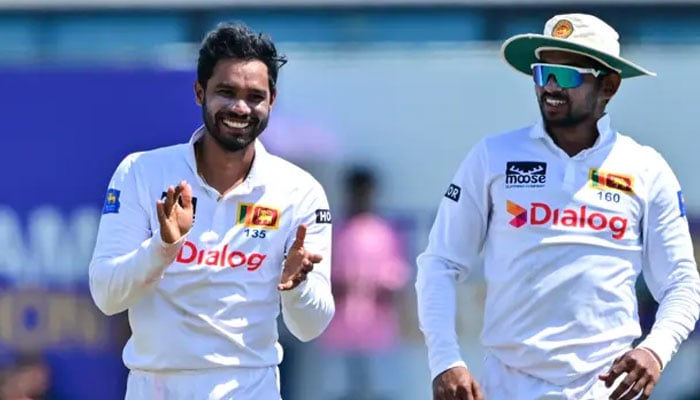 Sri Lankas Dhananjaya de Silva (left) and Kamindu Mendis celebrates after taking the wicket of New Zealands Devon Conway during the third day of the second Test cricket match between Sri Lanka and New Zealand at the Galle International Cricket Stadium in Galle on 28 September 2024. — AFP