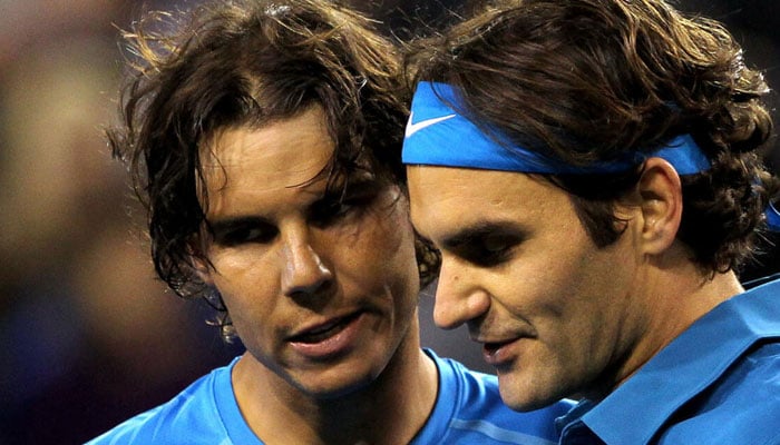 Rafael Nadal (left) talking to Roger Federer (right). — AFP/file