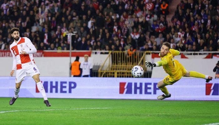 Croatias Josko Gvardiol (left) scores a goal past Portugals Jose Sa. — Reuters/File