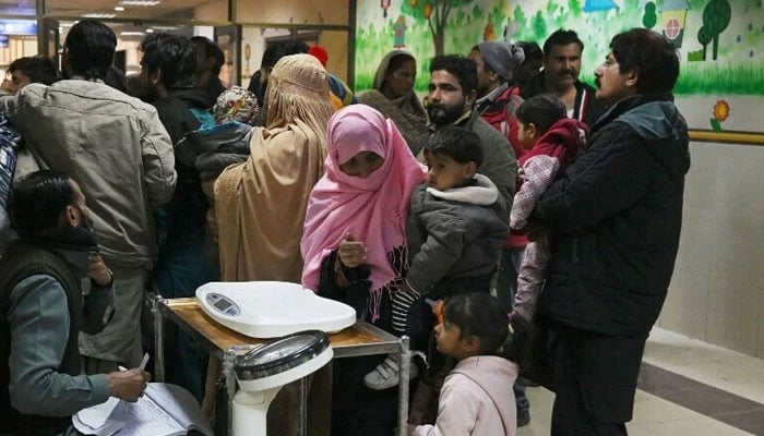 Representational image shows parents waiting with their children at a hospital. — AFP/File