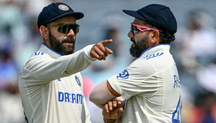 Indias Virat Kohli (left) and Rohit Sharma discussing strategies before heading into a five Test series against Australia. — AFP/file