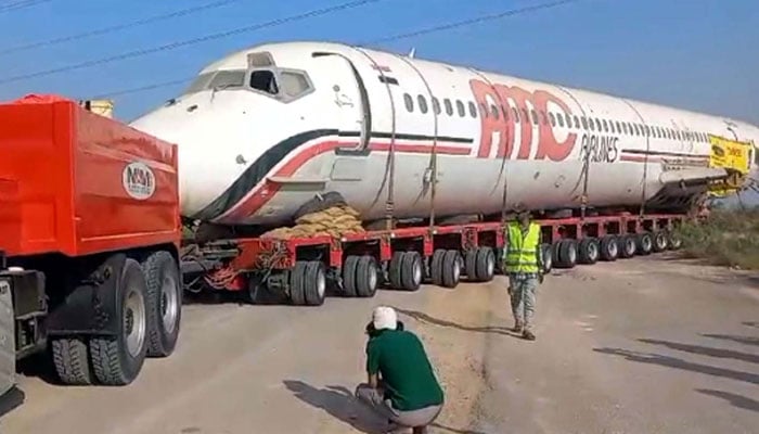 An aircraft is being transported from Karachi to Hyderabad via road on November 20, 2024. — PPI