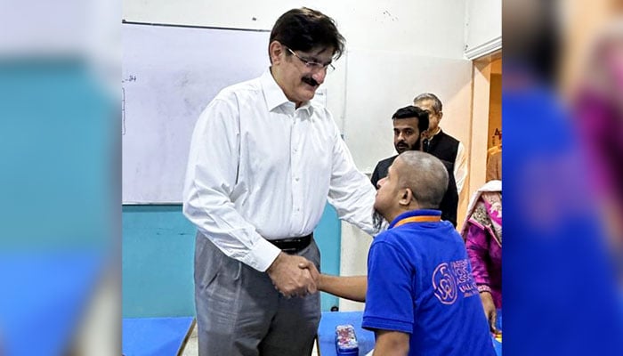 Sindh Chief Minister Syed Murad Ali Shah warmly shakes hands with a young man with disabilities during his classroom visit at the UJALA Center on November 20, 2024. — Facebook@SindhCMHouse